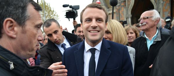 Emmanuel Macron, leader of En Marche! movement, center, is seen here in Le Touquet-Paris-Plage in the Pas-de-Calais department during the first round of the French presidential elections - Sputnik International