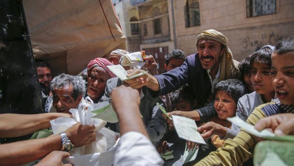 Yemenis receive food rations provided by a local charity, in Sanaa, Yemen, Thursday, April, 13, 2017 Yemenis receive food rations provided by a local charity, in Sanaa, Yemen, Thursday, April, 13, 2017 - Sputnik International