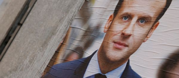 People walk past campaign posters of Emmanuel Macron (L), head of the political movement En Marche! (Onwards!), and Marine Le Pen (R), French National Front (FN) political party leader, two of the eleven candidates who run in the 2017 French presidential election, are seen in Paris, France, April 10, 2017 - Sputnik International