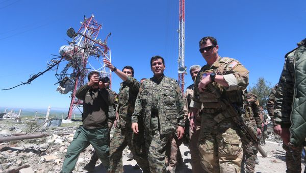 US military commander (R) walks with a commander (C) from the Kurdish People's Protection Units (YPG) as they inspect the damage at YPG headquarters after it was hit by Turkish airstrikes in Mount Karachok near Malikiya, Syria April 25, 2017. - Sputnik International