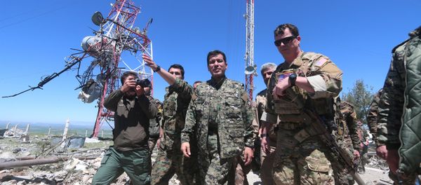 US military commander (R) walks with a commander (C) from the Kurdish People's Protection Units (YPG) as they inspect the damage at YPG headquarters after it was hit by Turkish airstrikes in Mount Karachok near Malikiya, Syria April 25, 2017. - Sputnik International