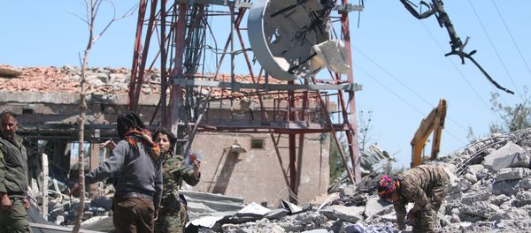 Fighters from the Kurdish People's Protection Units (YPG) inspect the damage at their headquarters after it was hit by Turkish airstrikes in Mount Karachok near Malikiya, Syria April 25, 2017 - Sputnik International