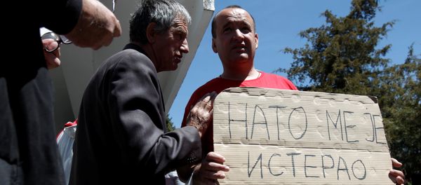 A protester holds a banner that reads NATO forced me out of Kosovo after a protest described as a parallel parliament, ahead of April 28's parliament vote to ratify the Montenegro's NATO membership, in the village of Murino, Montenegro, April 26, 2017 - Sputnik International