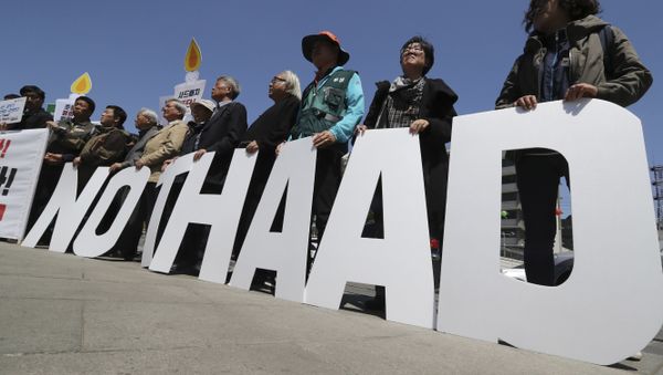 Protesters hold letters reading NO THAAD during a rally to oppose a plan to deploy an advanced U.S. missile defense system called Terminal High-Altitude Area Defense, or THAAD, near U.S. Embassy in Seoul, South Korea, Wednesday, April 26, 2017 - Sputnik International