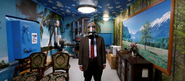 Seiichiro Nishimoto, CEO of Shelter Co., poses wearing a gas mask at a model room for the company's nuclear shelters in the basement of his house in Osaka, Japan April 26, 2017 - Sputnik International
