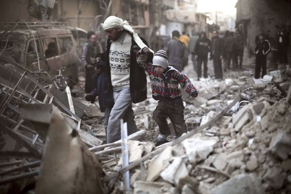 Man walks with a pair of children in hand hand through the rubble in Eastern Ghouta, Syria (File) Man walks with a pair of children in hand hand through the rubble in Eastern Ghouta, Syria (File) - Sputnik International