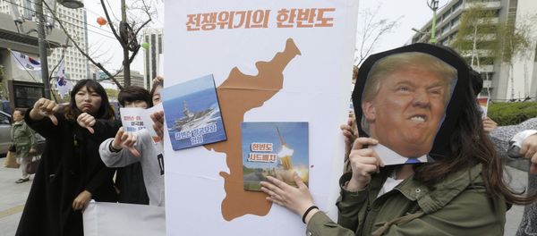 Protesters hold a cutout of U.S. President Donald Trump and images of the USS Carl Vinson aircraft carrier and U.S. missile defense system THAAD, right, on a map of Korean Peninsula during a rally against U.S. deployment of the aircraft carrier to the Korean Peninsula, near the U.S. embassy in Seoul, South Korea, Thursday, April 13, 2017 Protesters hold a cutout of U.S. President Donald Trump and images of the USS Carl Vinson aircraft carrier and U.S. missile defense system THAAD, right, on a map of Korean Peninsula during a rally against U.S. deployment of the aircraft carrier to the Korean Peninsula, near the U.S. embassy in Seoul, South Korea, Thursday, April 13, 2017 - Sputnik International