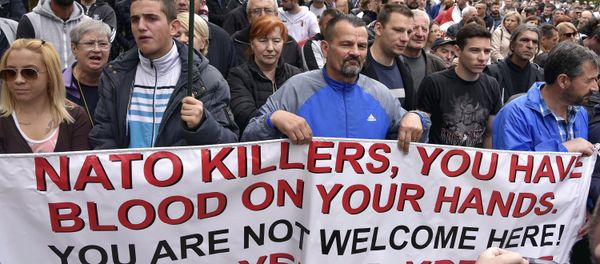 Anti-NATO demonstrators hold a banner during a protest outside the hall before the parliament session in Cetinje, Montenegro, Friday, April 28, 2017 Anti-NATO demonstrators hold a banner during a protest outside the hall before the parliament session in Cetinje, Montenegro, Friday, April 28, 2017 - Sputnik International