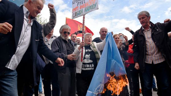 Demonstrators burn NATO flag during anti-NATO protest as Montenegro's parliament discuss ratification of NATO membership agreement in Cetinje, Montenegro, April 28, 2017 Demonstrators burn NATO flag during anti-NATO protest as Montenegro's parliament discuss ratification of NATO membership agreement in Cetinje, Montenegro, April 28, 2017 - Sputnik International