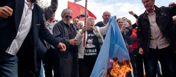 Demonstrators burn NATO flag during anti-NATO protest as Montenegro's parliament discuss ratification of NATO membership agreement in Cetinje, Montenegro, April 28, 2017 - Sputnik International