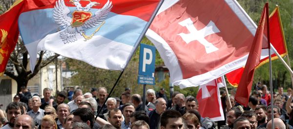 Demonstrators wave flags during anti-NATO protest as Montenegro’s parliament discusses NATO membership agreement in Cetinje, Montenegro, April 28, 2017 - Sputnik International