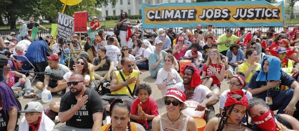 Demonstrators sit on the ground along Pennsylvania Ave. in front of the White House in Washington, Saturday, April 29, 2017, during a demonstration and march. - Sputnik International