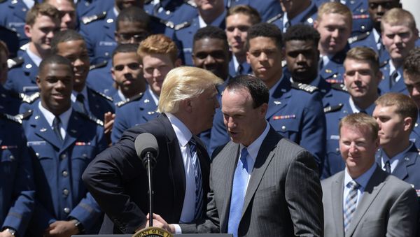 President Donald Trump talks with U.S. Air Force Academy football team coach Troy Calhoun in the Rose Garden of the White House in Washington - Sputnik International