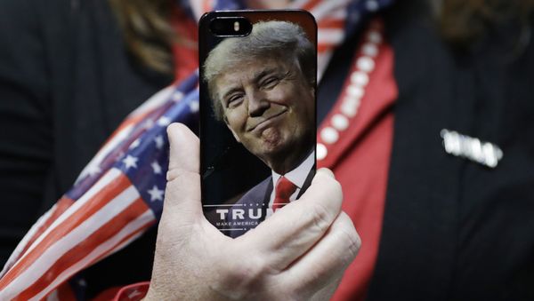 In this Thursday, Sept. 29, 2016, file photo, a woman holds up her cell phone before a rally with then presidential candidate Donald Trump in Bedford, N.H. In this Thursday, Sept. 29, 2016, file photo, a woman holds up her cell phone before a rally with then presidential candidate Donald Trump in Bedford, N.H. - Sputnik International
