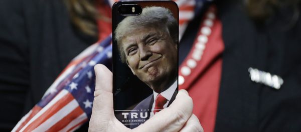 In this Thursday, Sept. 29, 2016, file photo, a woman holds up her cell phone before a rally with then presidential candidate Donald Trump in Bedford, N.H. - Sputnik International