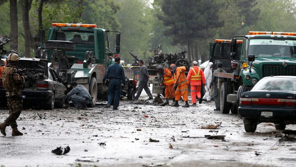 Afghan police and municipal workers clear debris from the site of a suicide bomb attack in Kabul, Afghanistan May 3, 2017 Afghan police and municipal workers clear debris from the site of a suicide bomb attack in Kabul, Afghanistan May 3, 2017 - Sputnik International