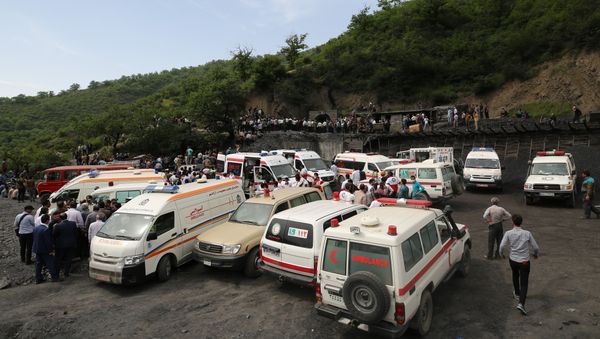 Rescue workers gather at the scene following an explosion in a coal mine in Azadshahr, in northern Iran, leaving dozens of miners trapped on May 3, 2017 - Sputnik International