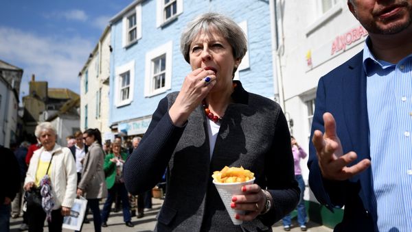 Britain's Prime Minister Theresa May enjoys some chips during a campaign stop in Mevagissey, Cornwall, May 2, 2017 Britain's Prime Minister Theresa May enjoys some chips during a campaign stop in Mevagissey, Cornwall, May 2, 2017 - Sputnik International