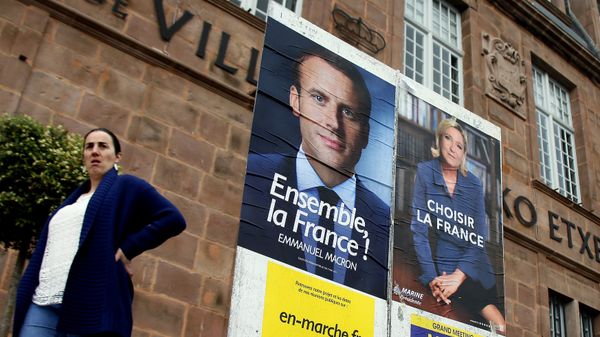 A woman walks near election campaign posters for French centrist presidential candidate Emmanuel Macron, left, and far-right candidate Marine Le Pen, in Saint Jean Pied de Port, southwestern France, Friday May 5, 2017 A woman walks near election campaign posters for French centrist presidential candidate Emmanuel Macron, left, and far-right candidate Marine Le Pen, in Saint Jean Pied de Port, southwestern France, Friday May 5, 2017 - Sputnik International