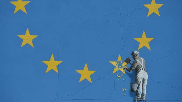 A section of an artwork attributed to street artist Banksy, depicting a workman chipping away at one of the 12 stars on the flag of the European Union, is seen on a wall in the ferry port of Dover. A section of an artwork attributed to street artist Banksy, depicting a workman chipping away at one of the 12 stars on the flag of the European Union, is seen on a wall in the ferry port of Dover. - Sputnik International