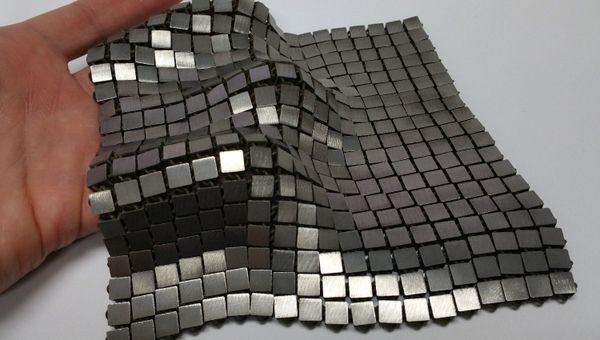 This metallic space fabric was created using 3-D printed techniques that add different functionality to each side of the material. - Sputnik International