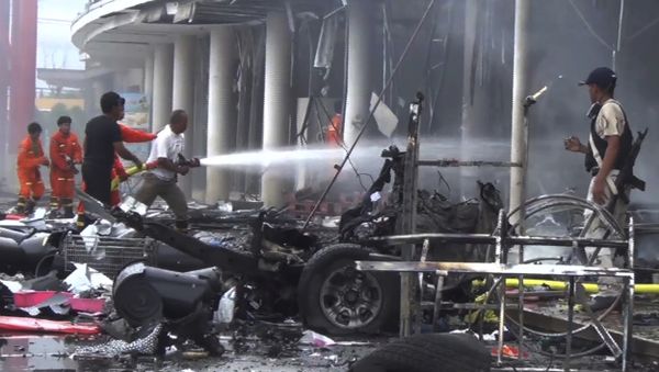 Firefighters try to extinguish the fire after a bomb hidden in a car exploded outside a large shopping center in Pattani province, southern Thailand - Sputnik International