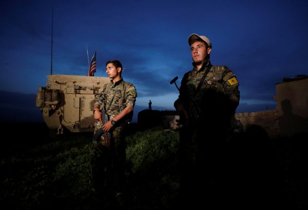 Kurdish fighters from the People's Protection Units (YPG) stand near a US military vehicle in the town of Darbasiya next to the Turkish border, Syria April 28, 2017.  - Sputnik International