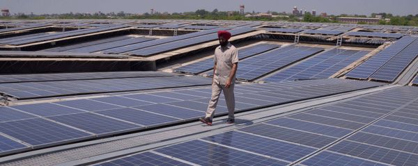 An Indian security personnel poses for media as he walks over rooftops covered in solar panels at the Solar Photovoltaic Power Plant, some 45kms from Amritsar. (File) An Indian security personnel poses for media as he walks over rooftops covered in solar panels at the Solar Photovoltaic Power Plant, some 45kms from Amritsar. (File) - Sputnik International