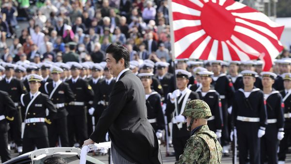 Japanese Prime Minister Shinzo Abe, center standing, reviews members of Japan Self-Defense Forces (SDF) during the Self-Defense Forces Day at Asaka Base, north of Tokyo, Sunday, Oct. 23, 2016. - Sputnik International