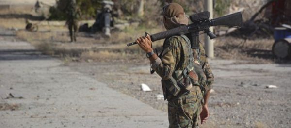 In this undated photo released Thursday, May 11, 2017, by Hawar News, the news agency for the semi-autonomous Kurdish areas in Syria, shows fighters from the Kurdish-led Syria Democratic Forces, patrolling on a street in Tabqa, northern Syria - Sputnik International