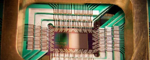 Photograph of a chip constructed by D-Wave Systems Inc. designed to operate as a 128-qubit superconducting adiabatic quantum optimization processor, mounted in a sample holder Photograph of a chip constructed by D-Wave Systems Inc. designed to operate as a 128-qubit superconducting adiabatic quantum optimization processor, mounted in a sample holder - Sputnik International