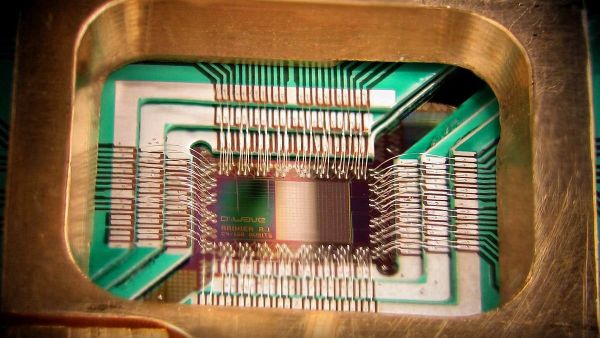 Photograph of a chip constructed by D-Wave Systems Inc. designed to operate as a 128-qubit superconducting adiabatic quantum optimization processor, mounted in a sample holder - Sputnik International