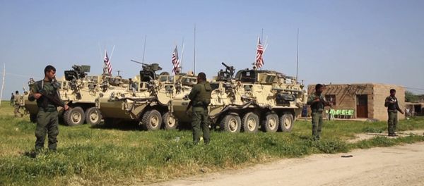 This Saturday, April. 29, 2017 still taken from video, shows Kurdish fighters of the People's Protection Units (YPG) standing guard as U.S. forces take up positions in the northern village of Darbasiyah, Syria - Sputnik International