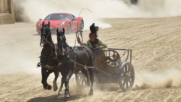 Ferrari driver Fabio Barone steers his Ferrari 458 Italia during a race against a Roman chariot drawn by two horses on Ben Hur movie set at Cinecitta World amusement park on May 11, 2017 in Castel Romano near Rome. - Sputnik International