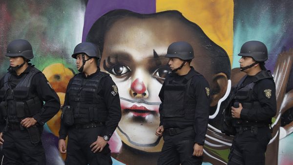 In this Monday, Jan. 9, 2017 photo, police providing security walk past street art as thousands march against the government of Enrique Pena Nieto following a 20 percent rise in gas prices in Mexico City. - Sputnik International
