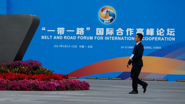 A man walks past the China National Convention Center, a venue of the upcoming Belt and Road Forum in Beijing, China, May 12, 2017 A man walks past the China National Convention Center, a venue of the upcoming Belt and Road Forum in Beijing, China, May 12, 2017 - Sputnik International