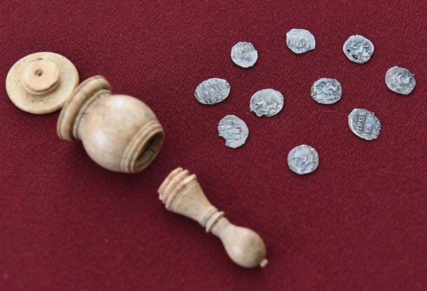 Hand minted silver coins from the time of Ivan the Terrible (16th century) that were found inside an ivory chess bishop figure shown as part of a display of archeological finds discovered in Prechistenka Street as it was being renovated under the My Street programme in Moscow - Sputnik International