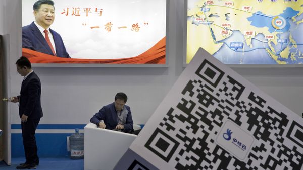 Visitors at a technology conference wait near illuminated boards highlighting Chinese President Xi Jinping's signature One Belt, One Road foreign policy plan in Beijing, China, Friday, April 28, 2017 - Sputnik International