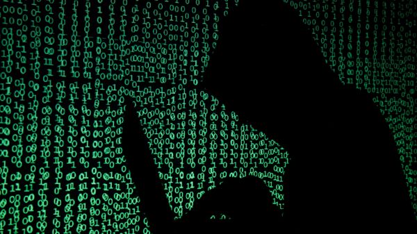 A hooded man holds a laptop computer as cyber code is projected on him in this illustration picture taken on May 13, 2017 - Sputnik International