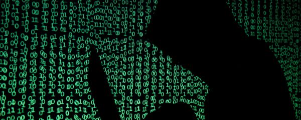 A hooded man holds a laptop computer as cyber code is projected on him in this illustration picture taken on May 13, 2017 - Sputnik International