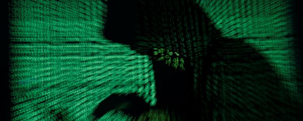 A hooded man holds a laptop computer as cyber code is projected on him in this illustration picture taken on May 13, 2017 A hooded man holds a laptop computer as cyber code is projected on him in this illustration picture taken on May 13, 2017 - Sputnik International