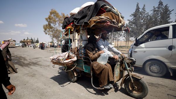 Internally displaced people who fled Raqqa city ride a tricycle with their belongings as they leave a camp in Ain Issa, Raqqa Governorate, Syria May 4, 2017 Internally displaced people who fled Raqqa city ride a tricycle with their belongings as they leave a camp in Ain Issa, Raqqa Governorate, Syria May 4, 2017 - Sputnik International
