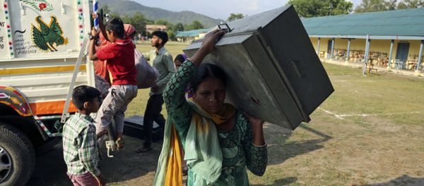 Indians evacuated from their village following cross-border shelling, arrive at a relief camp set up at a government school at Nowshera sector, along the highly militarized Line of Control that divides the region between India and Pakistan, Saturday, May 13, 2017 - Sputnik International