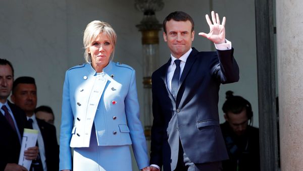 French President Emmanuel Macron and his wife Brigitte Trogneux wave to French President Francois Hollande (not pictured) as he leaves after the handover ceremony at the Elysee Palace in Paris, France, May 14, 2017 French President Emmanuel Macron and his wife Brigitte Trogneux wave to French President Francois Hollande (not pictured) as he leaves after the handover ceremony at the Elysee Palace in Paris, France, May 14, 2017 - Sputnik International