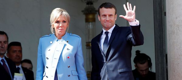 French President Emmanuel Macron and his wife Brigitte Trogneux wave to French President Francois Hollande (not pictured) as he leaves after the handover ceremony at the Elysee Palace in Paris, France, May 14, 2017 - Sputnik International