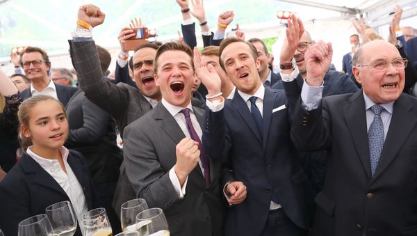 (L-R) Julius and Johannes Laschet, Sons of Armin Laschet, top candidate of the Christian Democratic Union (CDU) and his father Heinz Laschet react on first exit polls after the regional state elections of North Rhine-Westphalia, in Duesseldorf, May 14, 2017 - Sputnik International