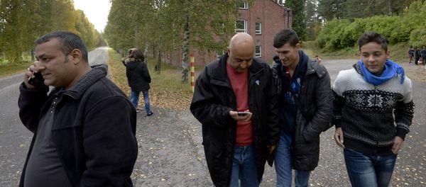 In this photo taken Friday, Sept. 25, 2015, Iraqi asylum seekers stand outside a refugee center located in the former army barracks, Lahti, Finland. Finland In this photo taken Friday, Sept. 25, 2015, Iraqi asylum seekers stand outside a refugee center located in the former army barracks, Lahti, Finland. Finland - Sputnik International