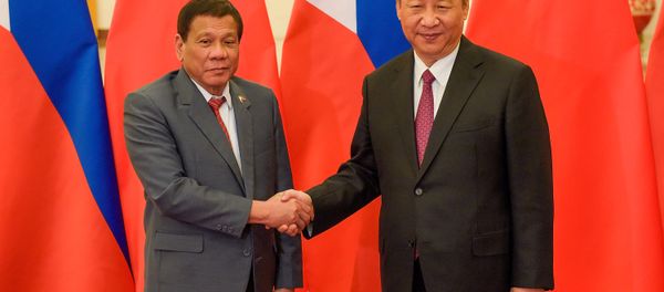 Chinese President Xi Jinping (R) shakes hands with Philippines President Rodrigo Duterte prior to their bilateral meeting during the Belt and Road Forum, at the Great Hall of the People in Beijing, China May 15, 2017. Chinese President Xi Jinping (R) shakes hands with Philippines President Rodrigo Duterte prior to their bilateral meeting during the Belt and Road Forum, at the Great Hall of the People in Beijing, China May 15, 2017. - Sputnik International