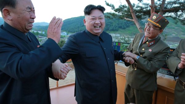 North Korean leader Kim Jong Un reacts with members of the Korean People's Army scientists and engineers in this undated photo released by North Korea's Korean Central News Agency (KCNA) on May 15, 2017. - Sputnik International