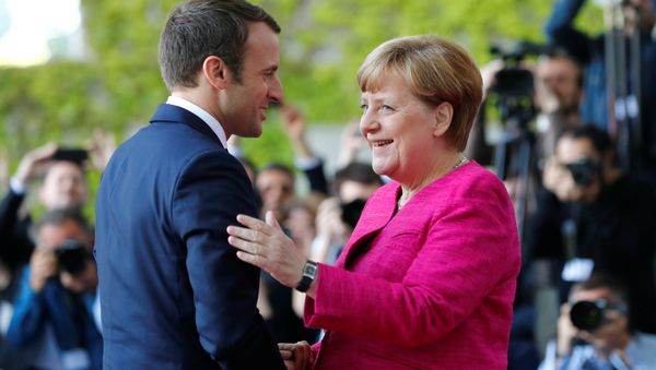 German Chancellor Angela Merkel welcomes French President Emmanuel Macron as they arrive at a ceremony at the Chancellery in Berlin, Germany, May 15, 2017. - Sputnik International